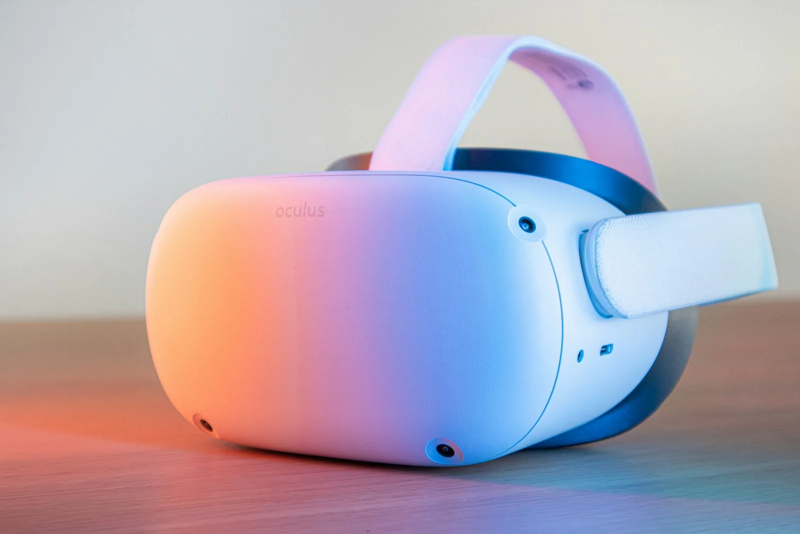 A pink and white VR headset lying on a table